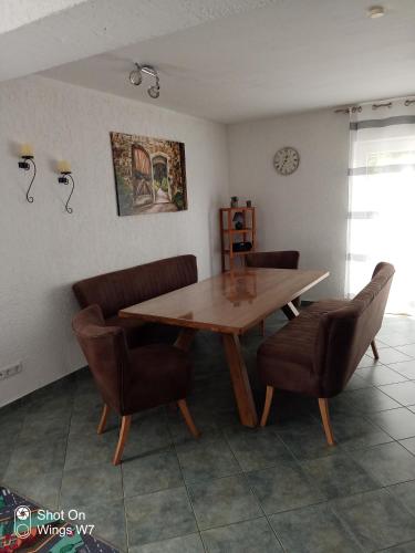 a dining room with a wooden table and chairs at Ferienhaus Mina im Harz in Stapelburg