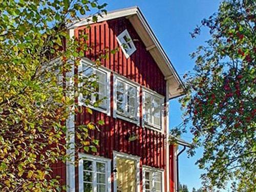 a red building with windows on the side of it at 8 person holiday home in Östmark in Östmark