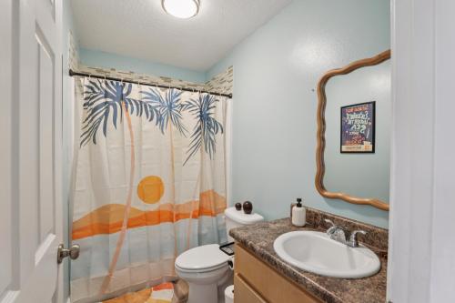 a bathroom with a sink and a shower curtain at Relaxing Pace Bay House home in Pace