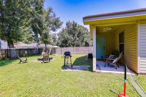 a backyard with chairs and a grill and a house at Relaxing Pace Bay House home in Pace