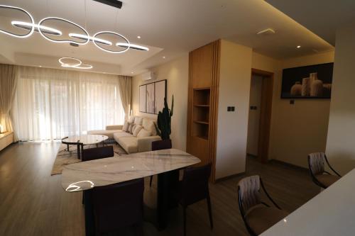 a living room with a couch and a table at Abrish Hotel and Apartment in Kampala