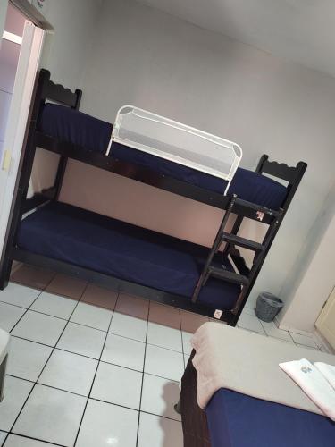 a room with two bunk beds in a room at Aloha Hostel Pinhões in Fortaleza