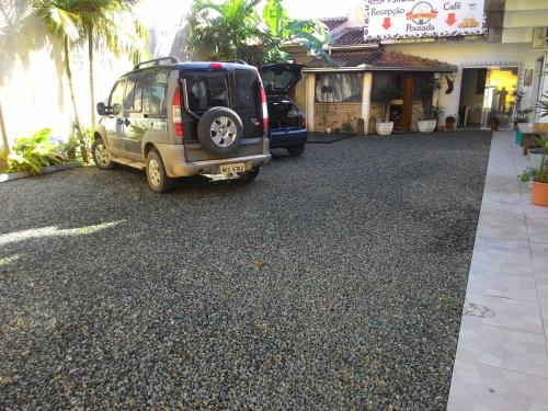 a van parked in front of a building at Pousada Vó Nita in Penha