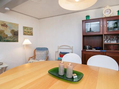 a dining room with a table with two candles on it at 3 person holiday home in Ærøskøbing in Ærøskøbing