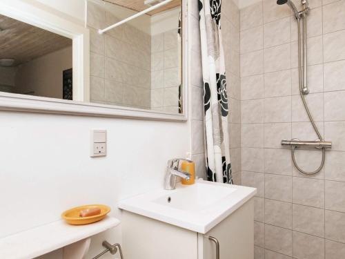 a white bathroom with a sink and a shower at 3 person holiday home in Ærøskøbing in Ærøskøbing