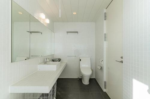 a white bathroom with a sink and a toilet at COCO VILLA 大洗-Sauna- in Oarai