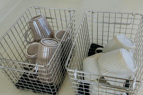 two wire baskets filled with pots and pans at COCO VILLA 大洗-Sauna- in Oarai
