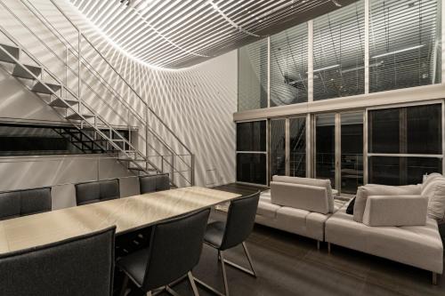 an office with a table and chairs and a staircase at COCO VILLA 大洗-Sauna- in Oarai