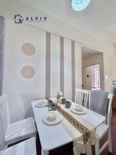a white dining room with a white table and chairs at Costa Mahkota - 1min I Mahkota Parade Mall I Dataran Pahlawan I Mahkota Hospital in Melaka