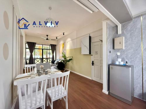 a kitchen and living room with a table and chairs at Costa Mahkota - 1min I Mahkota Parade Mall I Dataran Pahlawan I Mahkota Hospital in Melaka