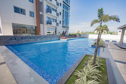 a swimming pool in the middle of a building at The Mactan Beach Haus in Punta Engaño