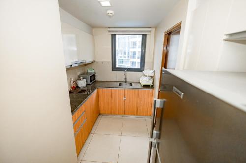 a small kitchen with a sink and a window at The Mactan Beach Haus in Punta Engaño
