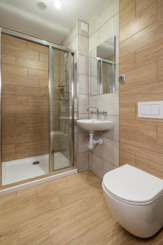 a bathroom with a toilet and a shower and a sink at U Chowańca in Murzasichle
