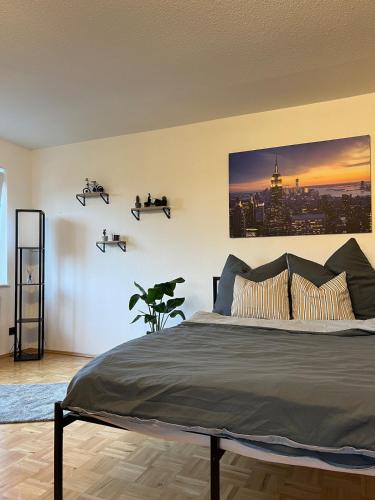 a bedroom with a bed with a poster on the wall at Apartment in Marburg in Marburg an der Lahn