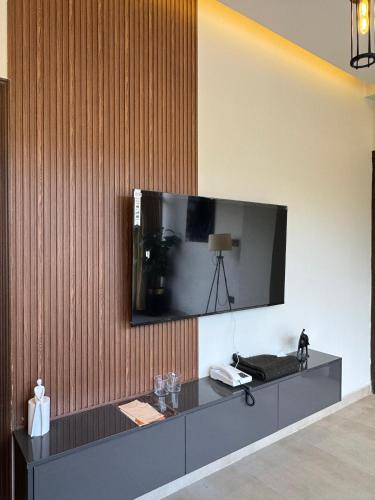 a television is mounted on a wall in a room at Munawar Residence in Muzaffarabad
