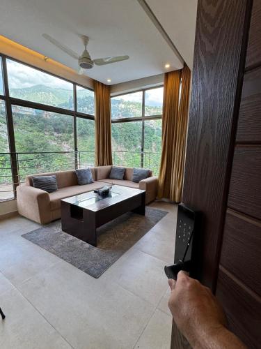 a living room with a couch and a coffee table at Munawar Residence in Muzaffarabad