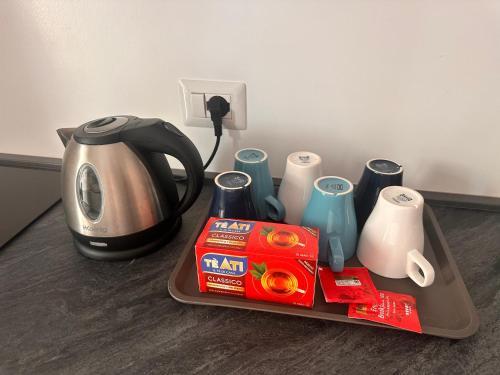 a tray with a coffee maker and a box of milk at Casa Del Grillo Parlante in Aragona