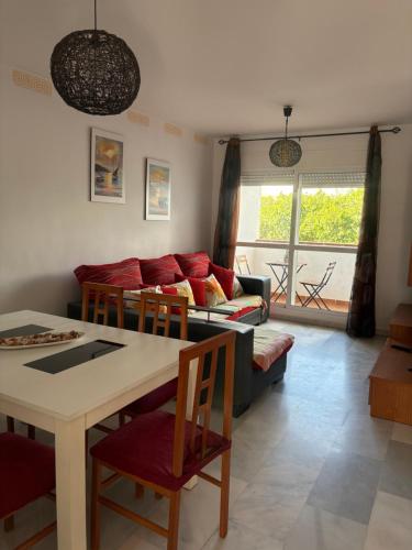 a living room with a couch and a table at Apartamento El Toyo in Almería