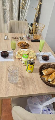 a wooden table with food and drinks on it at Hôtel in Bordj Bou Arreridj