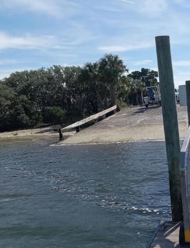 a bridge over a body of water next to a beach at Saltys Retreat with a 50 Ft Dock at Crystal River in Crystal River