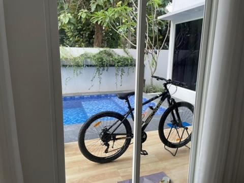 a bike parked in a room with a window at D'illy Borobudur Villa in Magelang