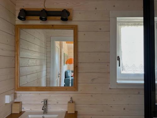a bathroom with a mirror and a sink at Cabana in Sesimbra