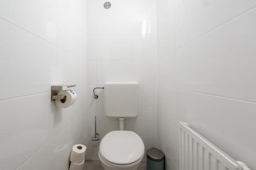 a bathroom with a white toilet in a white room at Vienna Stay Apartments Schönbrunn in Vienna