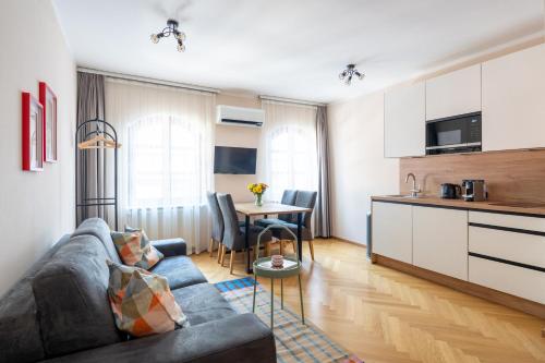 a living room with a couch and a table at Vienna Stay Apartments Schönbrunn in Vienna