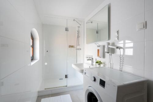 a white bathroom with a sink and a mirror at Vienna Stay Apartments Schönbrunn in Vienna