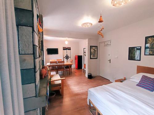 a room with a bed and a dining room at Omana Hotel in Kathmandu