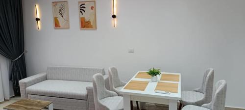 a living room with a table and chairs and a couch at Bay View, Sahl Hashish, Hurghada in Hurghada