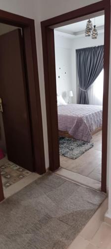 a reflection of a bedroom with a bed and a mirror at Bay View, Sahl Hashish, Hurghada in Hurghada