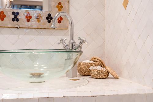 a glass sink on a counter in a bathroom at Kasbah Dream - Great Location in Tangier in Tangier
