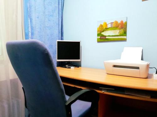 a desk with a computer monitor and a printer at Comfy Room With Working Space in top Location in Ivišovo Greblje