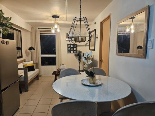 a kitchen and dining room with a table and chairs at Cozy 3-Bedroom Family Condo in Manila