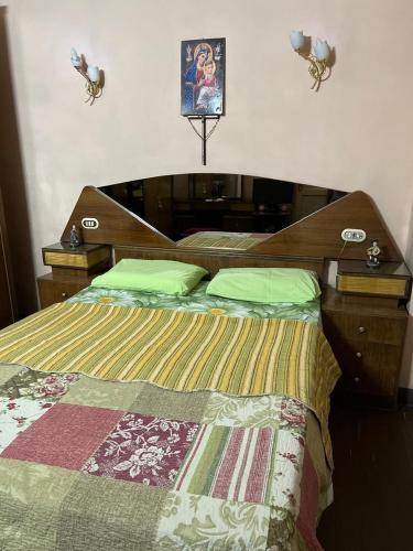 a bedroom with a bed with a wooden head board at Velvet Rose Apartment in Luxor