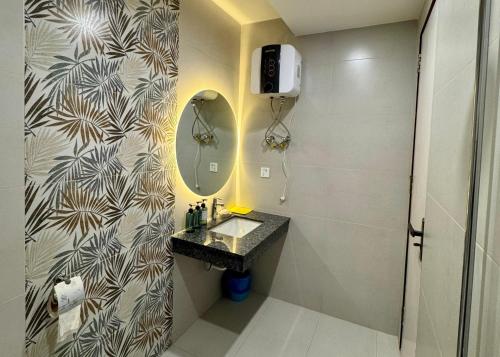 a bathroom with a sink and a mirror at Premium Pavilion in Islamabad
