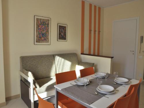 a dining room with a table and a couch at Holiday Home in Lazise near Lake Garda in Lazise