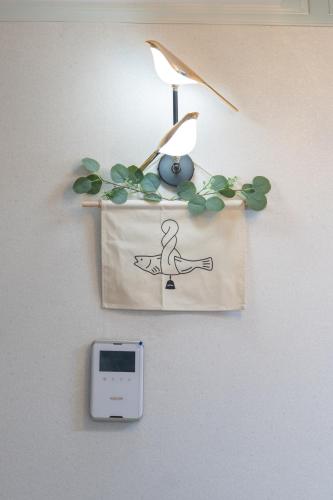 a clock hanging on a wall with a clock at 코지스테이 in Seoul