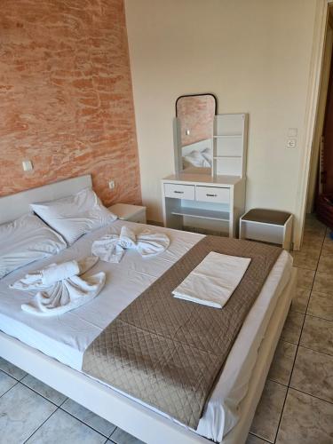 a bedroom with a bed with towels on it at Magafinis Apartment in Prinos