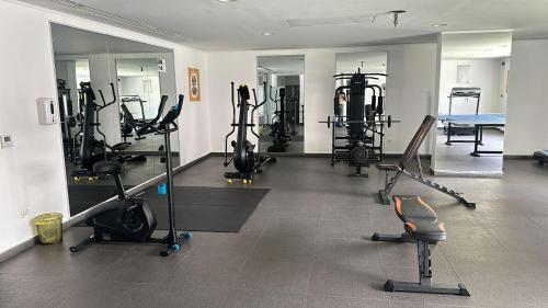 a gym with a bunch of exercise equipment in a room at Sloane House in Dzorwulu