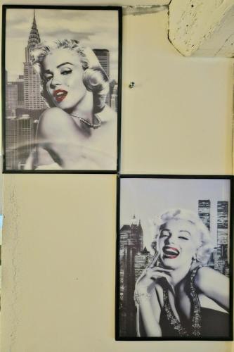 four pictures of a woman on a wall at Close to Karmøy and Haugesund airport in Karmøy