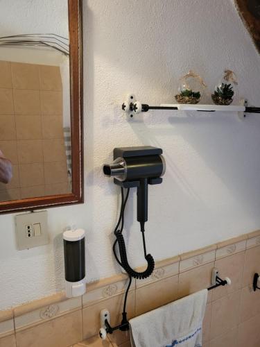 a hair drier on the wall of a bathroom at Klunj home in Buje