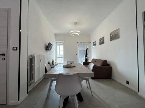a dining room and living room with a table and chairs at Metro Bengasi sotto casa, Turin top in Moncalieri