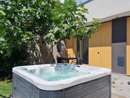 a jacuzzi tub in a yard next to a building at Füge-lak in Hajdúszoboszló