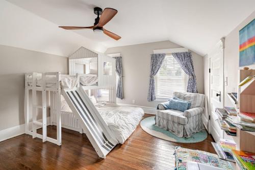 a bedroom with two bunk beds and a chair at Southern Charm & Modern Comfort in Jacksonville