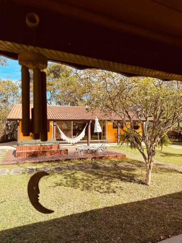 a view of a house with a tree in the yard at Chalés natureza in Jacareí