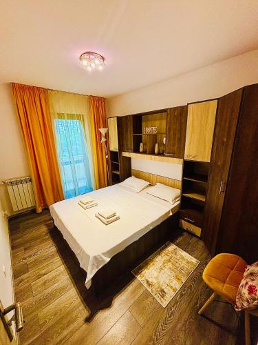 a bedroom with a large bed in a room at Olive Apartament 3 in Iaşi