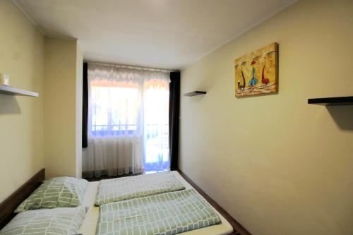 Postel nebo postele na pokoji v ubytování Family Holiday Apartman