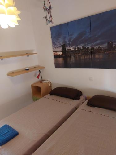 a room with two beds and a painting on the wall at Apartamento playas de Vera in Vera